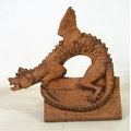 A modern cast terracotta roof ridge tile, modelled as a dragon with outswept wings, 46 by 26 by 43cm... 