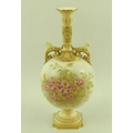 A Royal Worcester blush ivory bottle vase with dogs head moulded masks to the scrolled handles and G... 