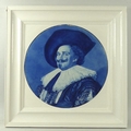 A large circular Delft tile painted in blue with The Laughing Cavalier by Frans Hals, back hand init... 