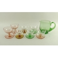 A harlequin set of seven sundae glass dishes, late 20th century, 9cm, together with a green glass ju... 