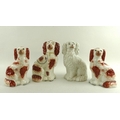 A group of four 19th century Staffordshire flatback figures, each modelled as a dog, one with all wh... 