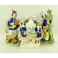 A group of three 19th century Staffordshire flat back figures, comprising a Scottish bagpiper, a sec... 