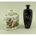 A 19th century porcelain tea caddy, the shaped body painted with exotically plumed birds and foliage... 
