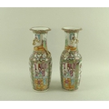 A pair of Canton porcelain baluster vases, 19th century, with moulded relief dragons chasing the fla... 