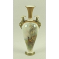 A Royal Worcester blush ivory porcelain vase of baluster form twin handled form, moulded with griffi... 