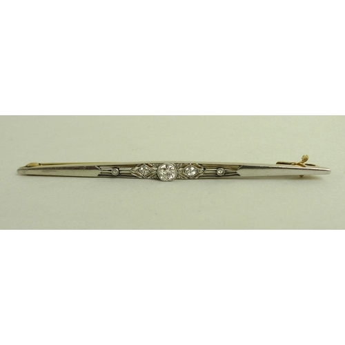 779 - An 18ct gold, platinum and diamond Art Deco bar brooch, set with five old brilliant cut diamonds, ce... 