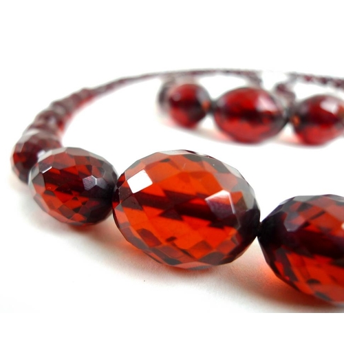 785 - Two similar strands of vintage facet cut amber beads of graduated size, one strand with seventy five... 