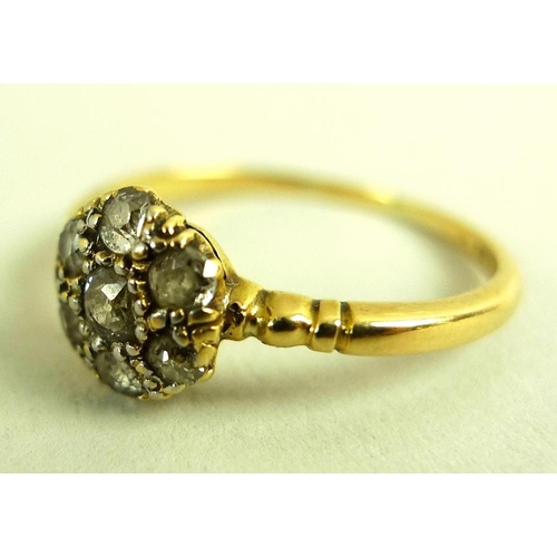 793 - An 18ct gold and diamond cluster ring, with central 0.125ct old cut diamond surrounded by six simila... 