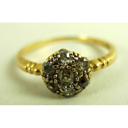 793 - An 18ct gold and diamond cluster ring, with central 0.125ct old cut diamond surrounded by six simila... 