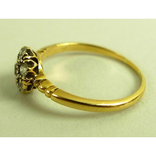 793 - An 18ct gold and diamond cluster ring, with central 0.125ct old cut diamond surrounded by six simila... 