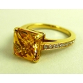 An 18K gold, diamond and citrine solitaire dress ring, the square cut citrine of approximately 8 by ... 