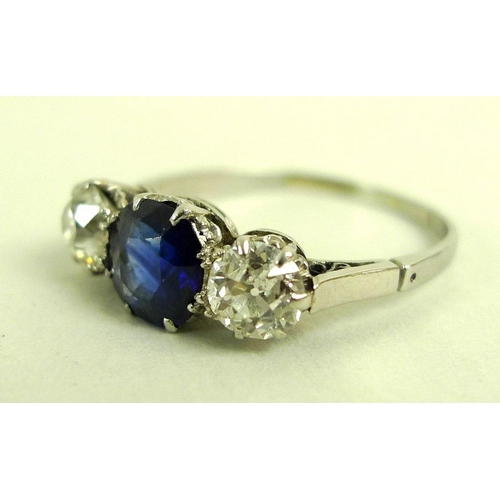 821 - A platinum, diamond and synthetic sapphire three stone ring with central sapphire of approximately 1... 