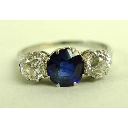 821 - A platinum, diamond and synthetic sapphire three stone ring with central sapphire of approximately 1... 