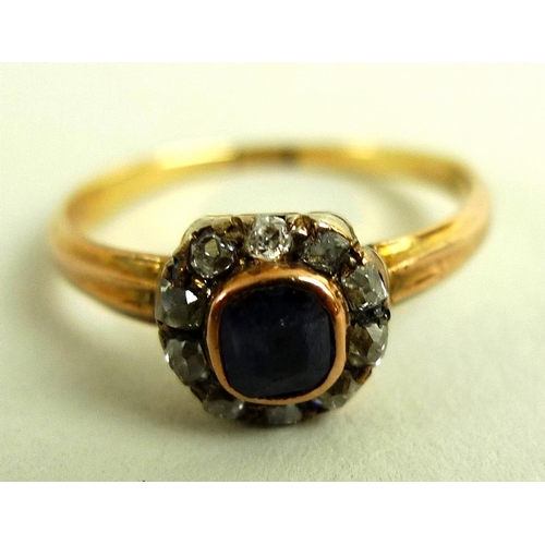 822 - An Edwardian 18ct gold, diamond and sapphire dress ring with central emerald cut sapphire surrounded... 