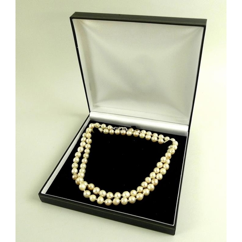 826 - A string of Baroque shaped pearls, with a white metal clasp, each approx 8mm, 84.7g, 87cm long, in a... 