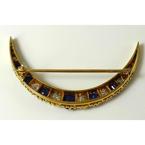 838 - An 18ct gold, diamond and sapphire crescent brooch, possibly Russian, set with twelve diamonds of gr... 