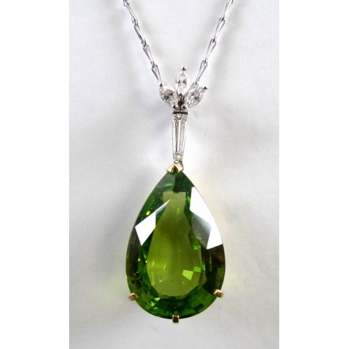 840 - An exceptional and large peridot, diamond and 18ct gold pendant, the pear cut peridot in the region ... 