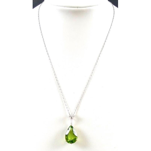 840 - An exceptional and large peridot, diamond and 18ct gold pendant, the pear cut peridot in the region ... 