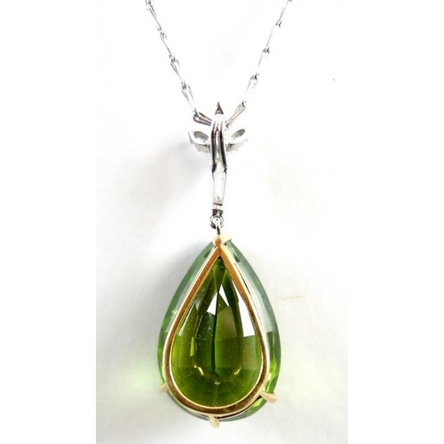 840 - An exceptional and large peridot, diamond and 18ct gold pendant, the pear cut peridot in the region ... 