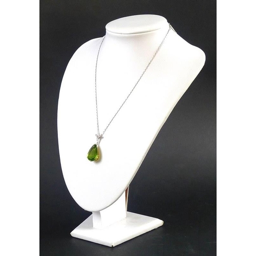 840 - An exceptional and large peridot, diamond and 18ct gold pendant, the pear cut peridot in the region ... 