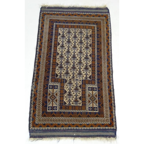 848 - A Kazak rug of geometric design, with cream ground, madder and dark blue decoration, finely woven fr... 