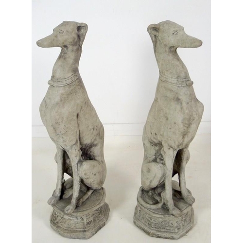 849 - A pair of modern cast garden sculptures, modelled as seated whippets seated, on octagonal bases, eac... 