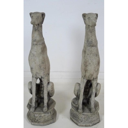 849 - A pair of modern cast garden sculptures, modelled as seated whippets seated, on octagonal bases, eac... 