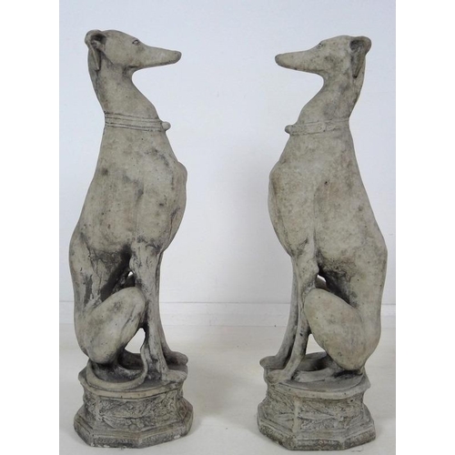 849 - A pair of modern cast garden sculptures, modelled as seated whippets seated, on octagonal bases, eac... 