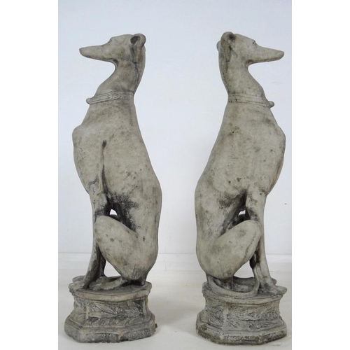 849 - A pair of modern cast garden sculptures, modelled as seated whippets seated, on octagonal bases, eac... 