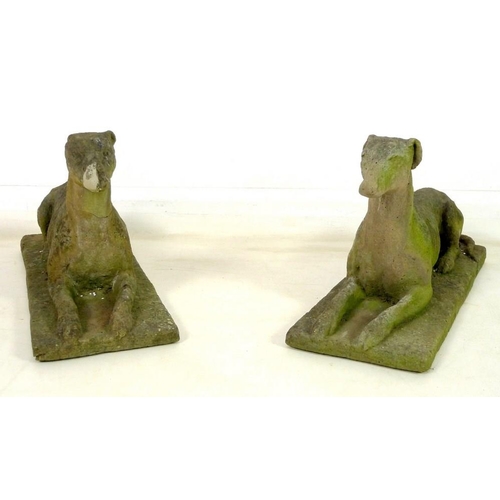 850 - A pair of 19th century carved stone figures, modelled as recumbent greyhounds, on integral rectangul... 