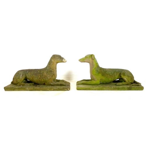 850 - A pair of 19th century carved stone figures, modelled as recumbent greyhounds, on integral rectangul... 