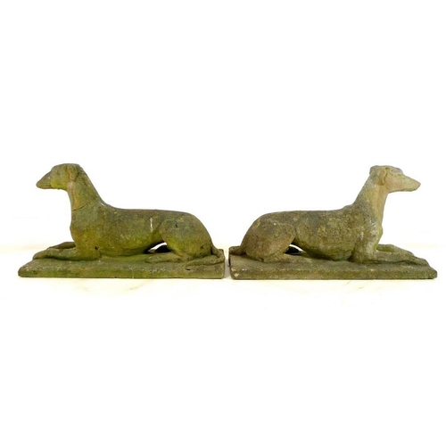 850 - A pair of 19th century carved stone figures, modelled as recumbent greyhounds, on integral rectangul... 