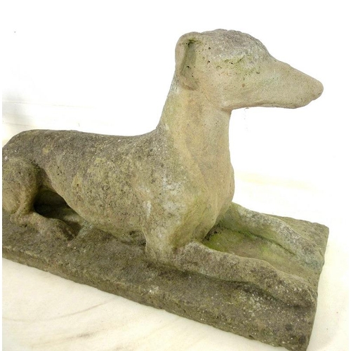 850 - A pair of 19th century carved stone figures, modelled as recumbent greyhounds, on integral rectangul... 