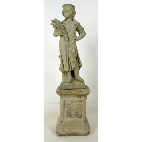 853 - A 19th century style reconstituted stone garden statue, cast as a girl standing holding a wheatsheaf... 