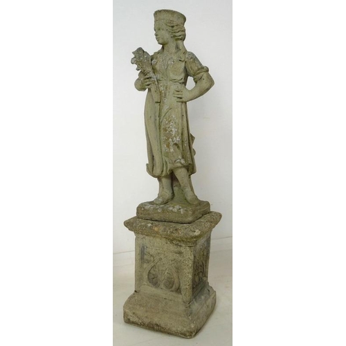 853 - A 19th century style reconstituted stone garden statue, cast as a girl standing holding a wheatsheaf... 