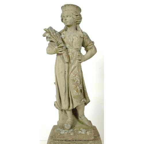 853 - A 19th century style reconstituted stone garden statue, cast as a girl standing holding a wheatsheaf... 