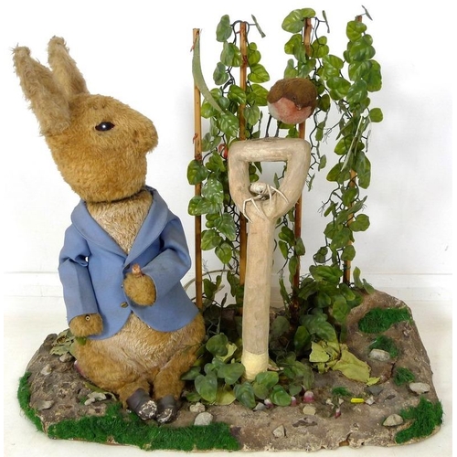 855 - A large automaton of Peter Rabbit in Mr McGregor's garden, mid to late 20th century, 95 by 36 by 77c... 