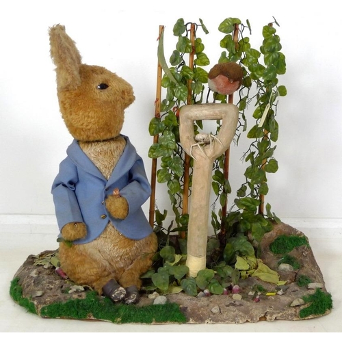 855 - A large automaton of Peter Rabbit in Mr McGregor's garden, mid to late 20th century, 95 by 36 by 77c... 