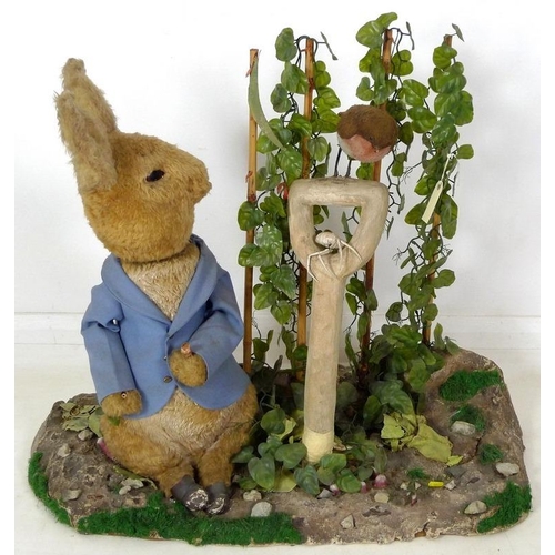 855 - A large automaton of Peter Rabbit in Mr McGregor's garden, mid to late 20th century, 95 by 36 by 77c... 