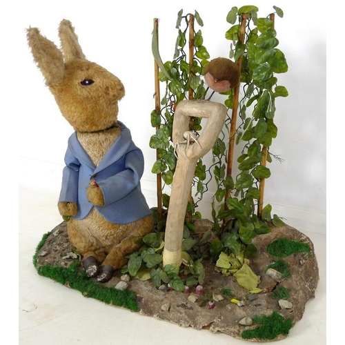 855 - A large automaton of Peter Rabbit in Mr McGregor's garden, mid to late 20th century, 95 by 36 by 77c... 