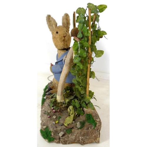 855 - A large automaton of Peter Rabbit in Mr McGregor's garden, mid to late 20th century, 95 by 36 by 77c... 