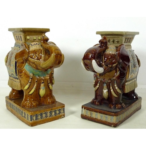 856 - A pair of Chinese style ceramic garden seats, in the form of elephants, in treacle glazes, 55 by 25 ... 