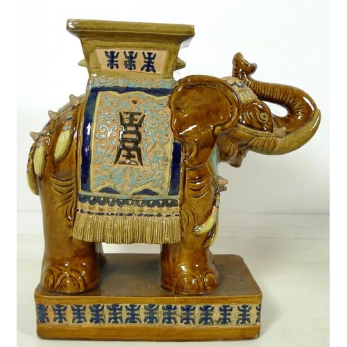 856 - A pair of Chinese style ceramic garden seats, in the form of elephants, in treacle glazes, 55 by 25 ... 