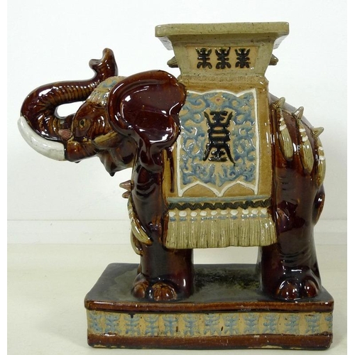 856 - A pair of Chinese style ceramic garden seats, in the form of elephants, in treacle glazes, 55 by 25 ... 