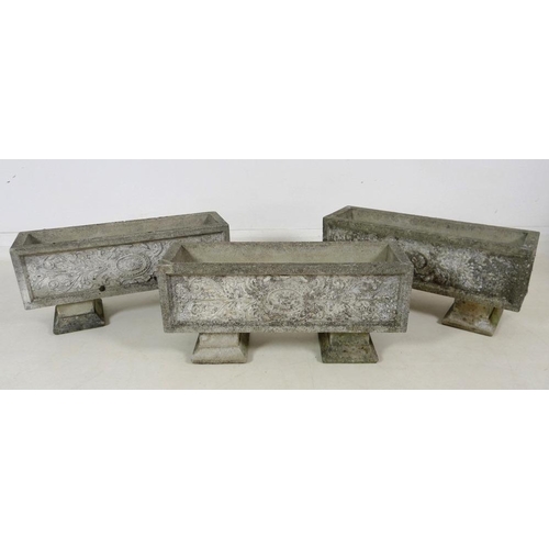 859 - Three modern reconstituted stone garden planters, each raised on two separate block feet, each 65 by... 