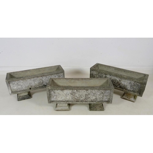 859 - Three modern reconstituted stone garden planters, each raised on two separate block feet, each 65 by... 