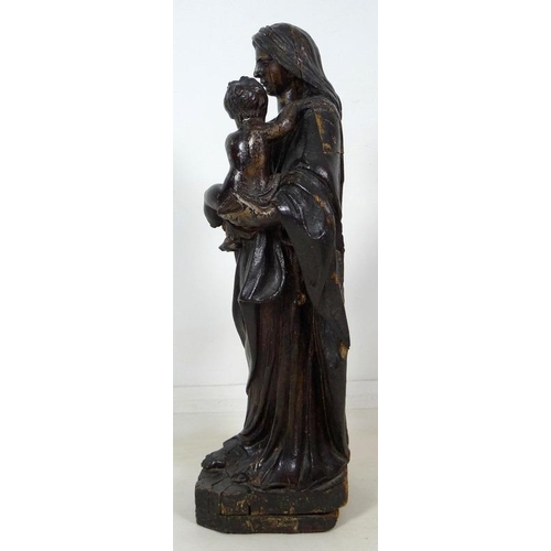 861 - A French carved and painted softwood Madonna and child, 17th century, raised on a square base with c... 