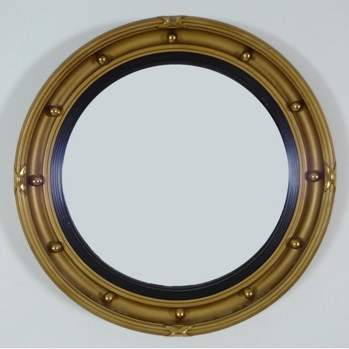 863 - An early 20th century gilt framed circular bull's eye mirror, the frame set with orbs, reeded and ri... 