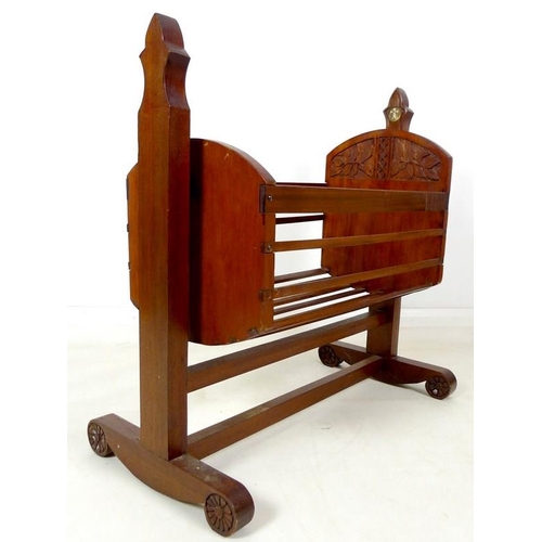 865 - An early to mid mahogany cradle and stand, carved in Arts and Crafts Gothic style, with bone or ivor... 