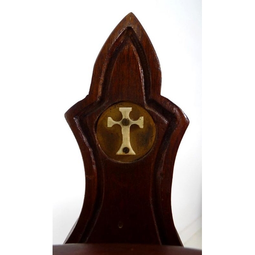 865 - An early to mid mahogany cradle and stand, carved in Arts and Crafts Gothic style, with bone or ivor... 